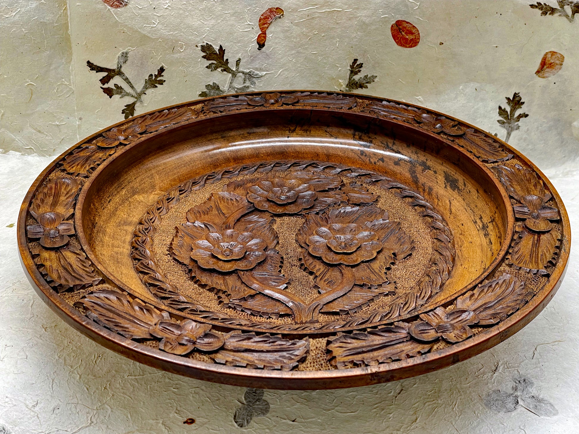 Large hand-carved wooden collector's plate with floral relief carving