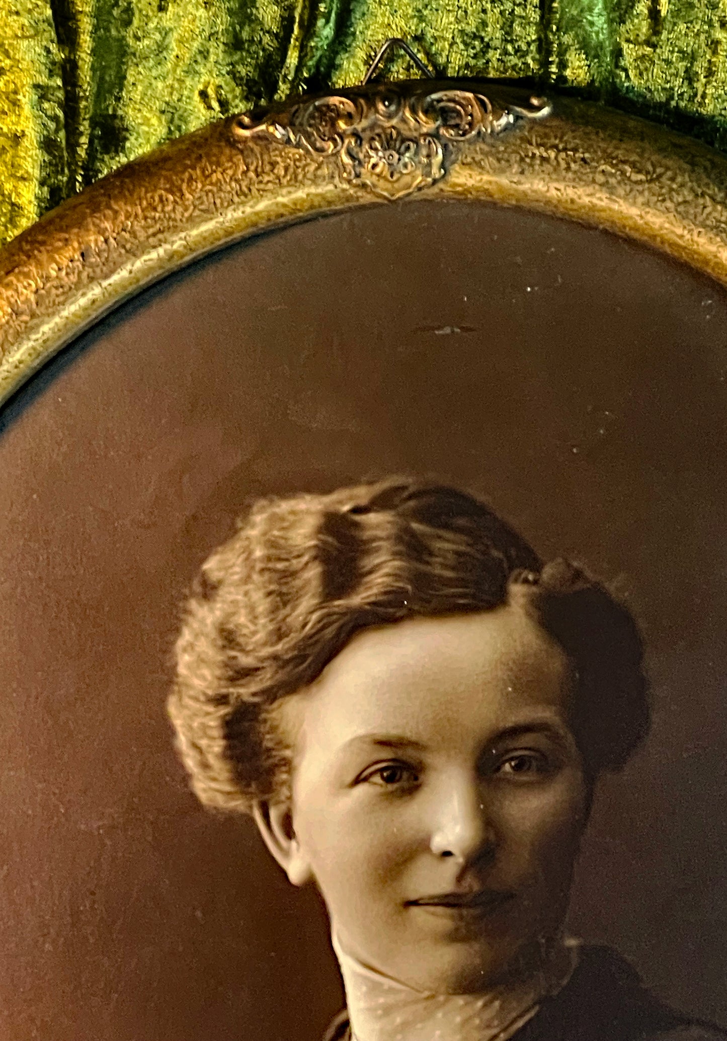 Detail of the young woman's face in the sepia portrait