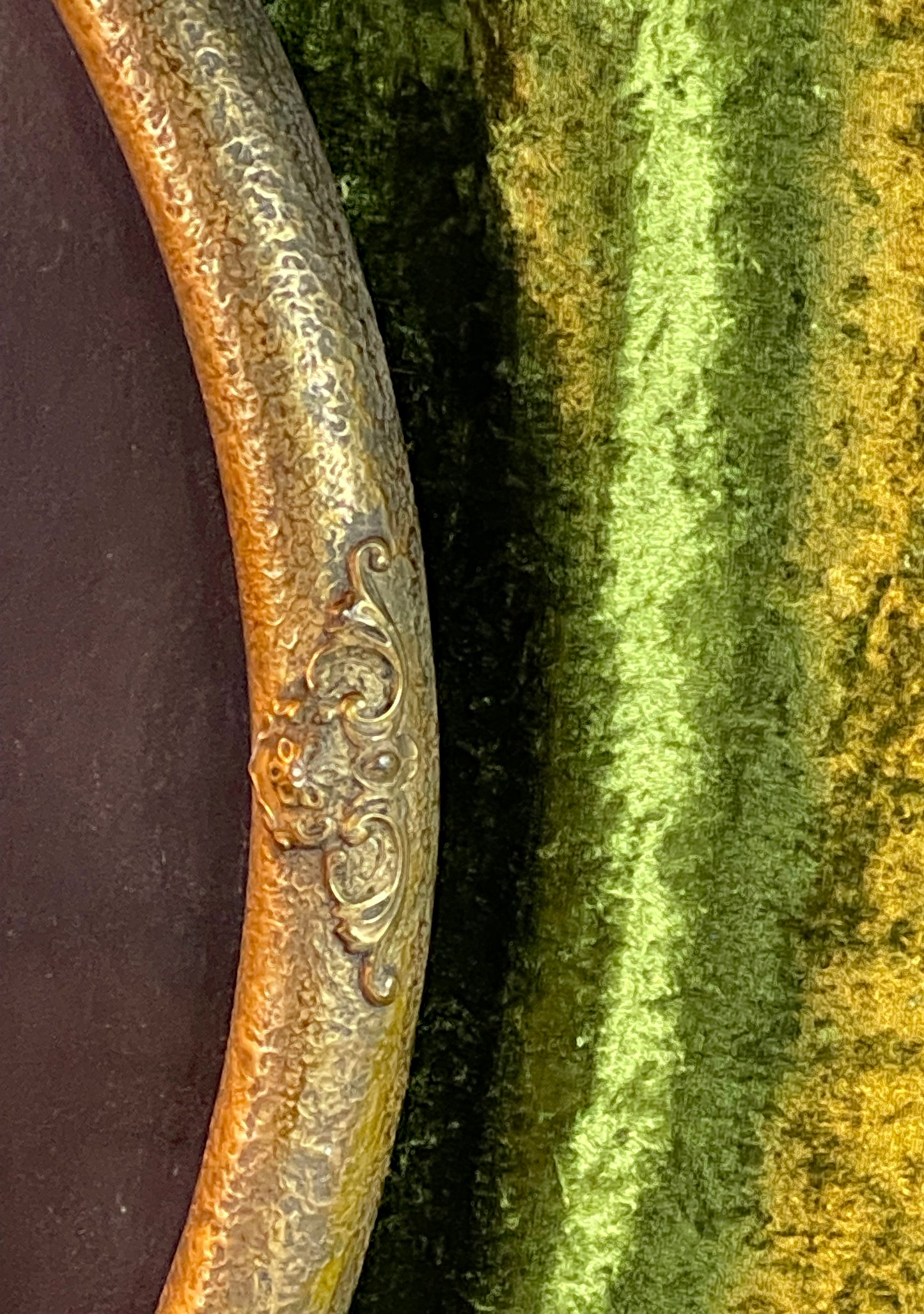 Detail of the gilded oval frame with corner ornaments