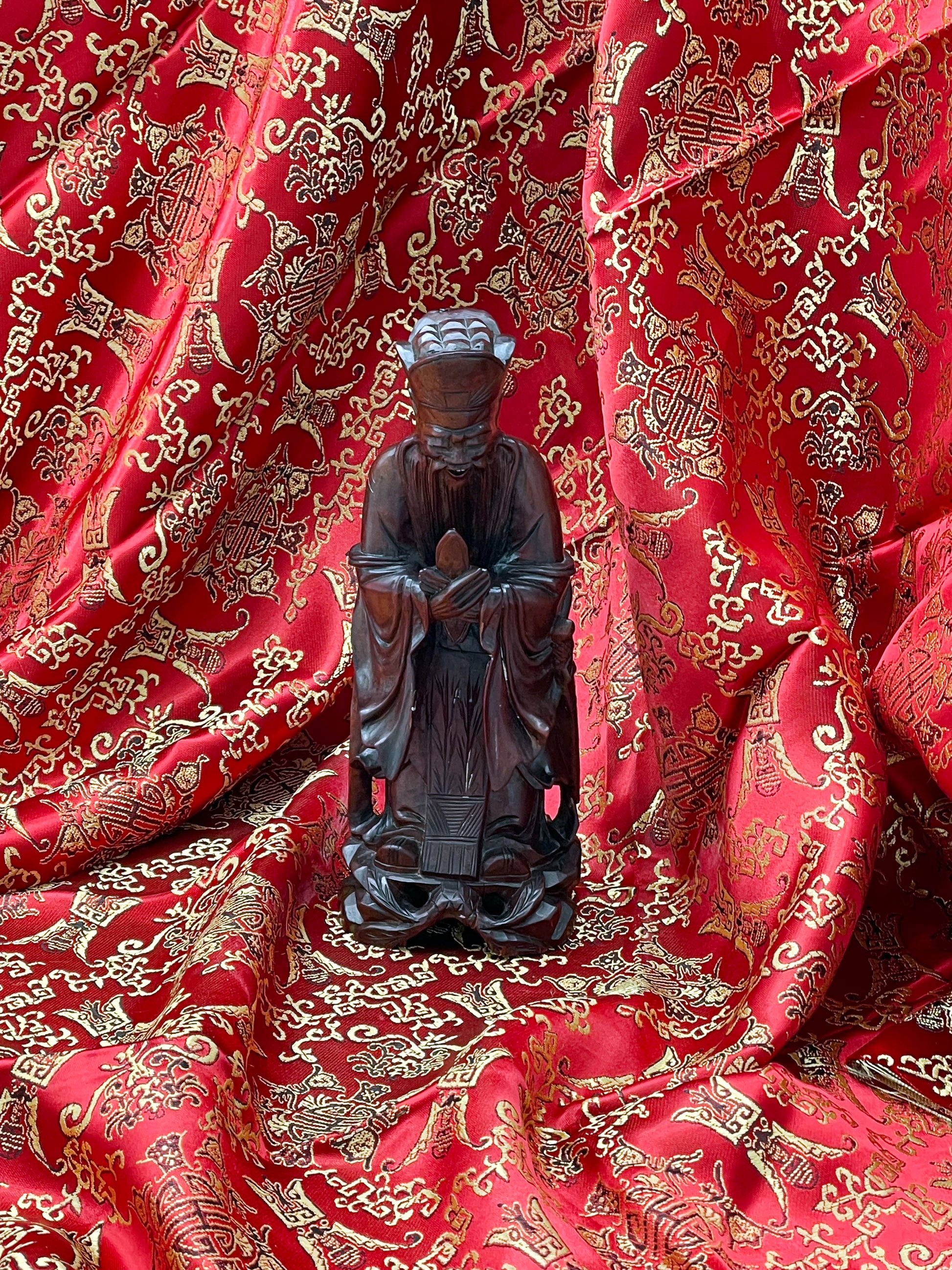 Carved hardwood Confucius figure detail