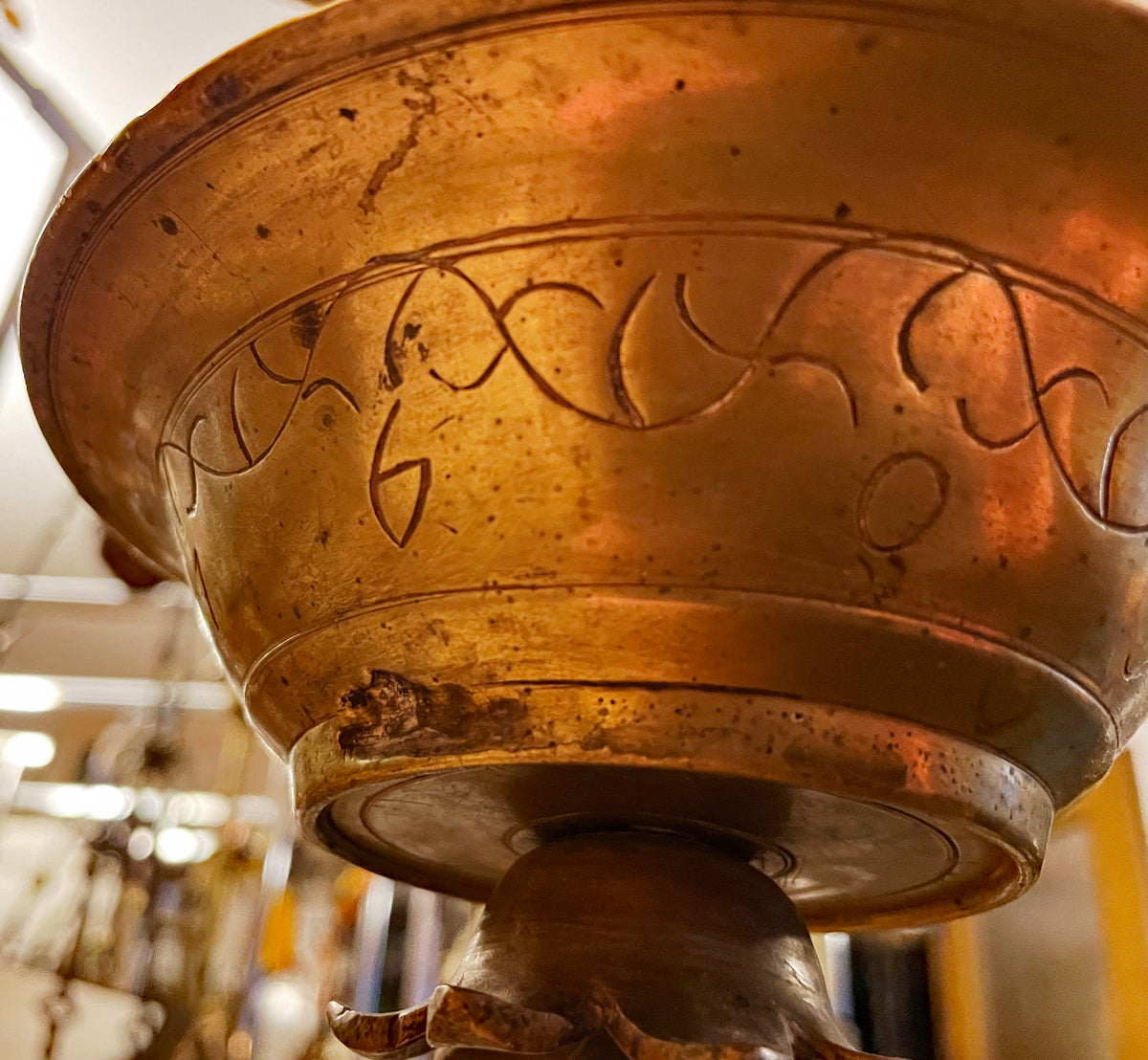 Drip bowl of the Shabbat lamp with engraved foliate band, seen from below