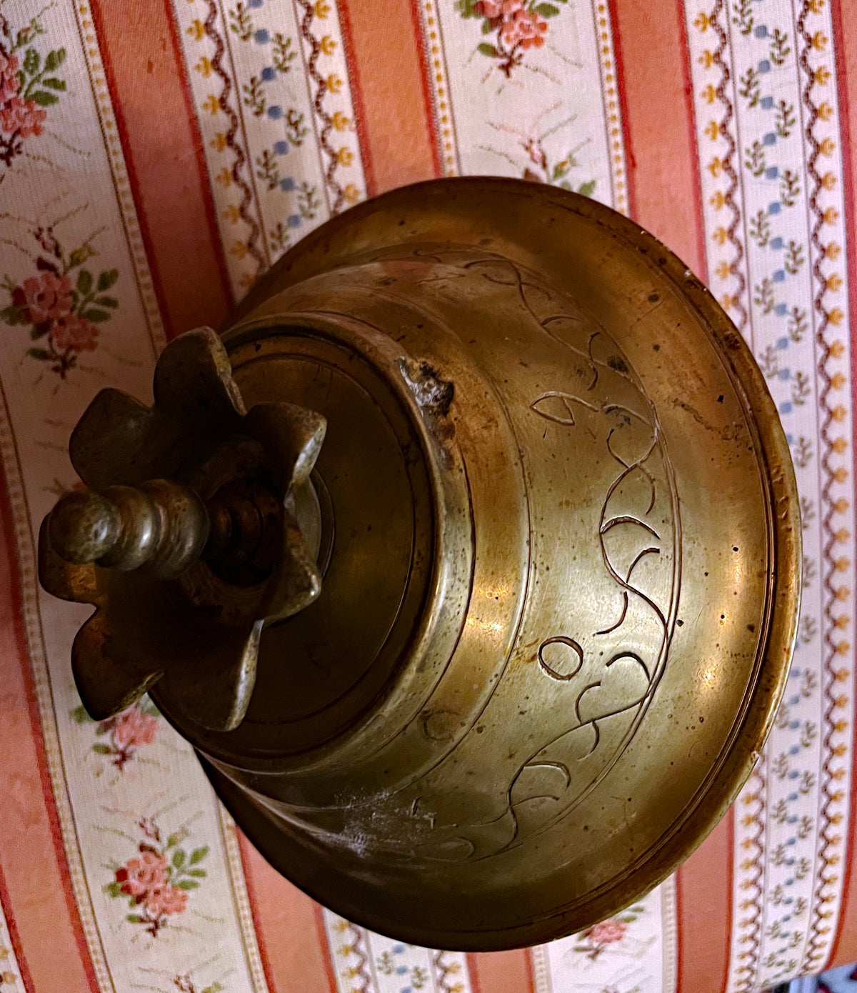 Drip bowl underside with petalled bronze finial