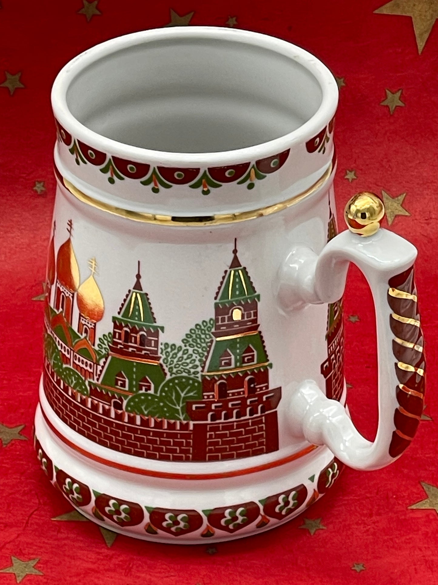 Detail of gold and green cathedral decoration on porcelain stein
