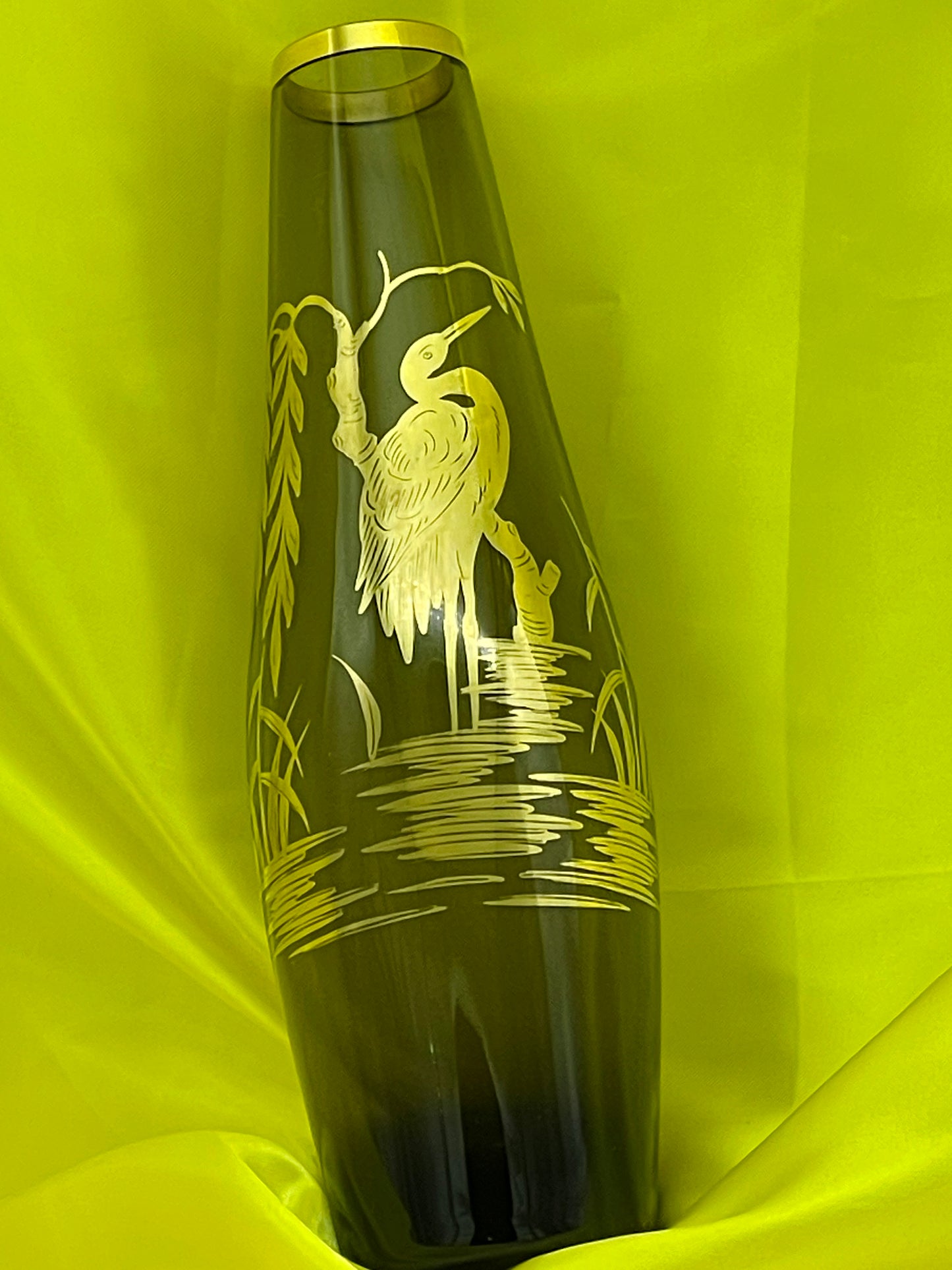 Detail of gilded heron and willow motif on green glass vase