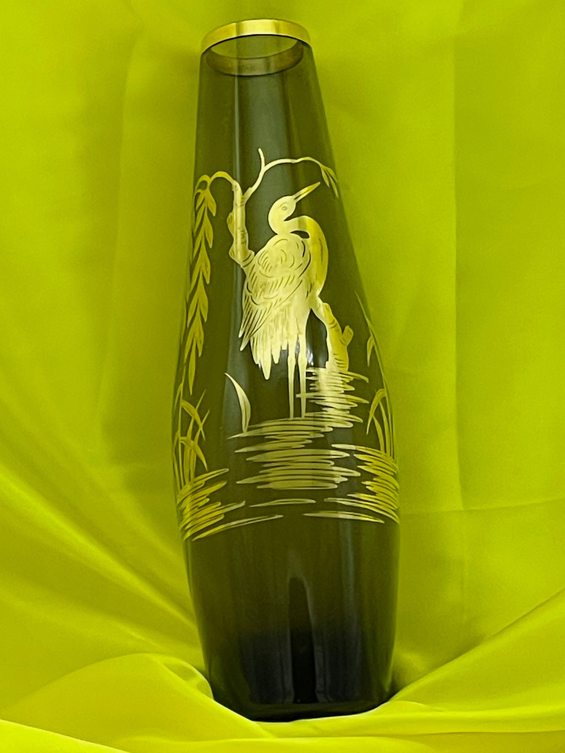 Green glass vase showing tapering silhouette