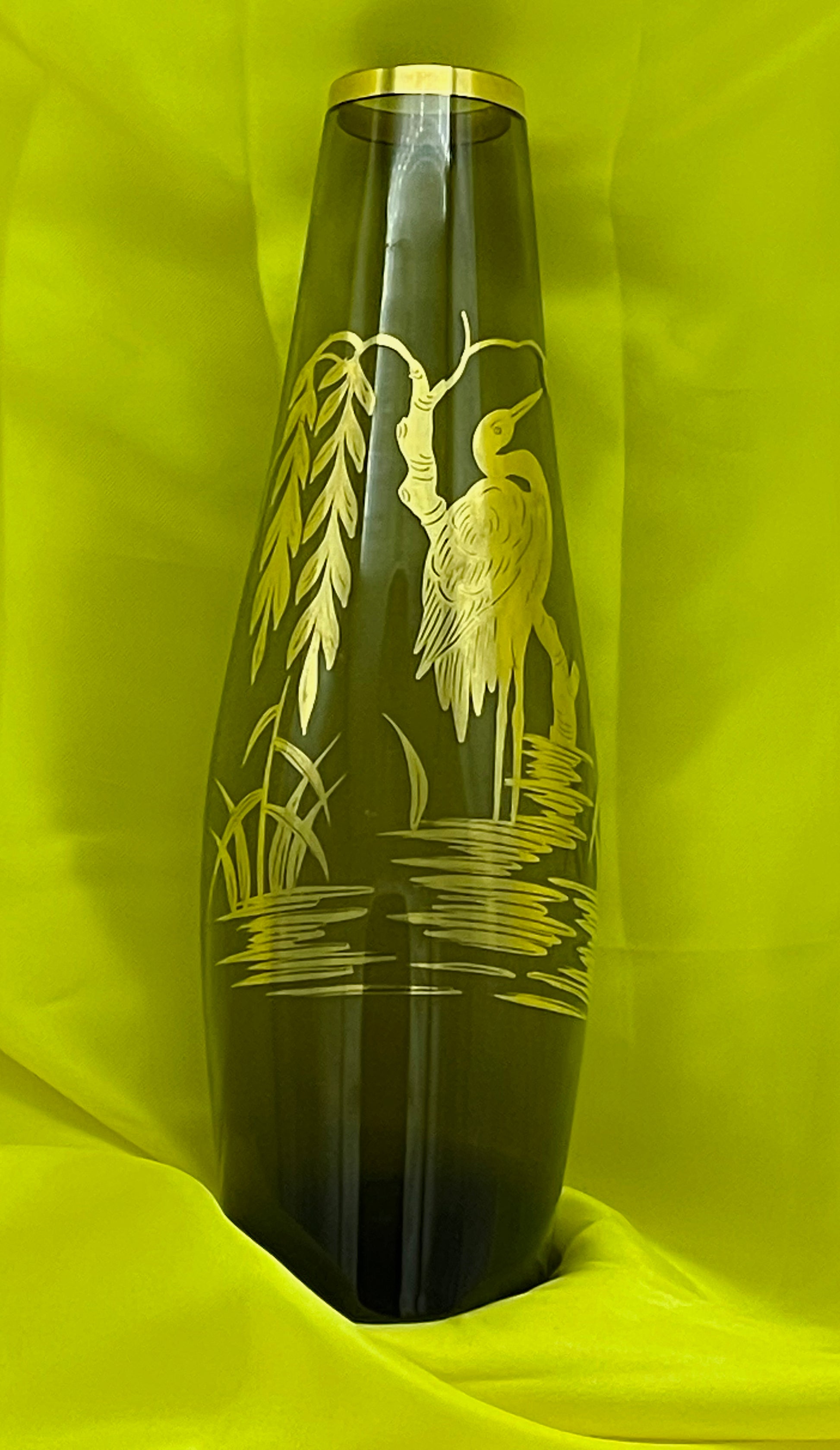 Crane motif close-up on green glass vase