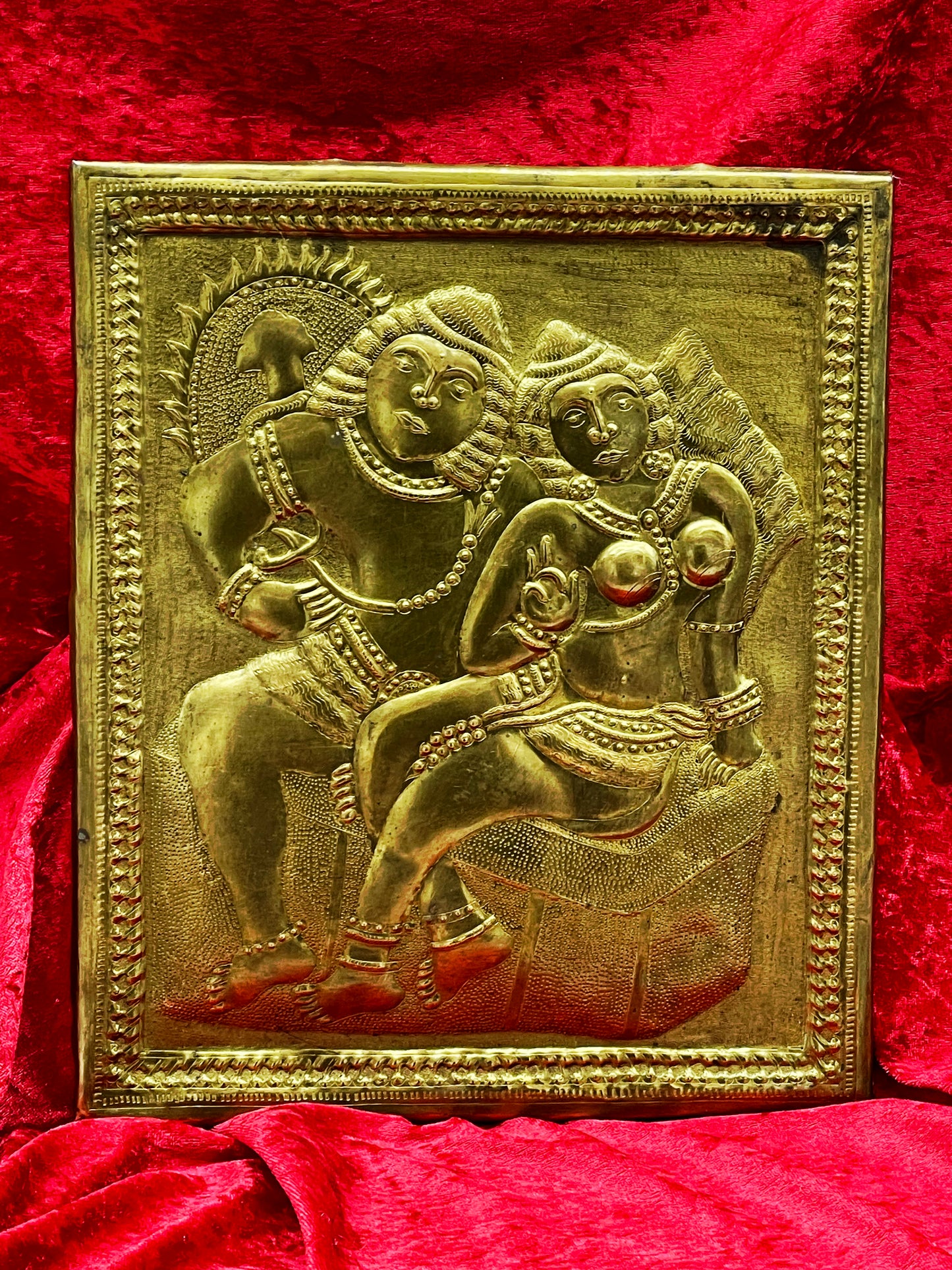 Antique Thai brass repoussé relief of Rama and Sita embracing, on red velvet