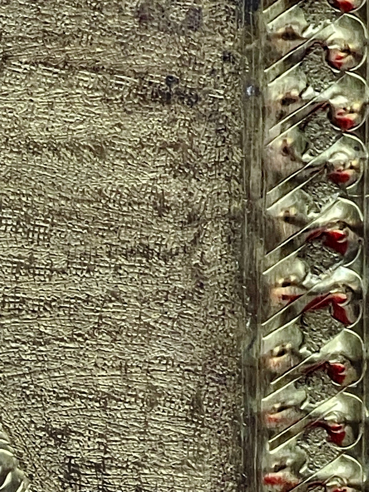 Twisted beaded border and finely punched background of the brass relief