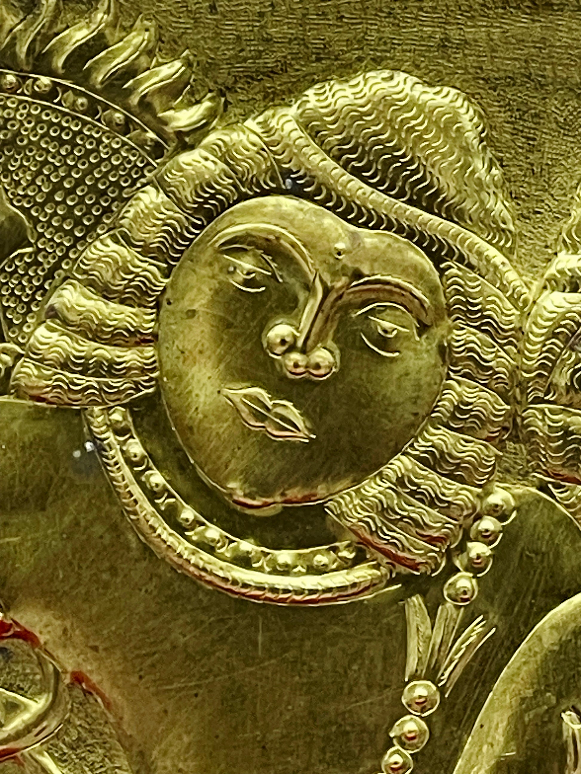 Close-up of Rama's serene face with finely chased crown and wavy hair