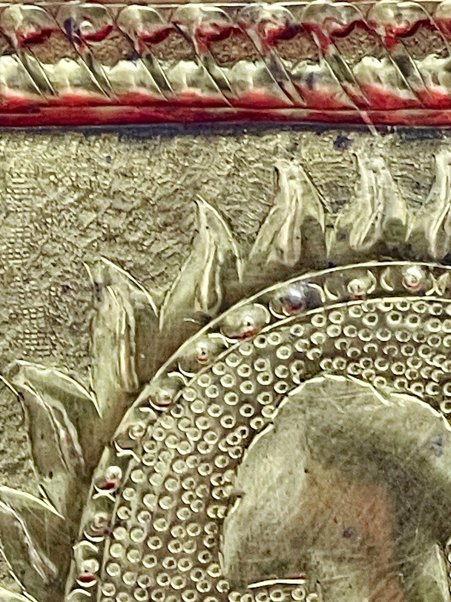 Detail of the punched aureole and beaded halo behind the figures