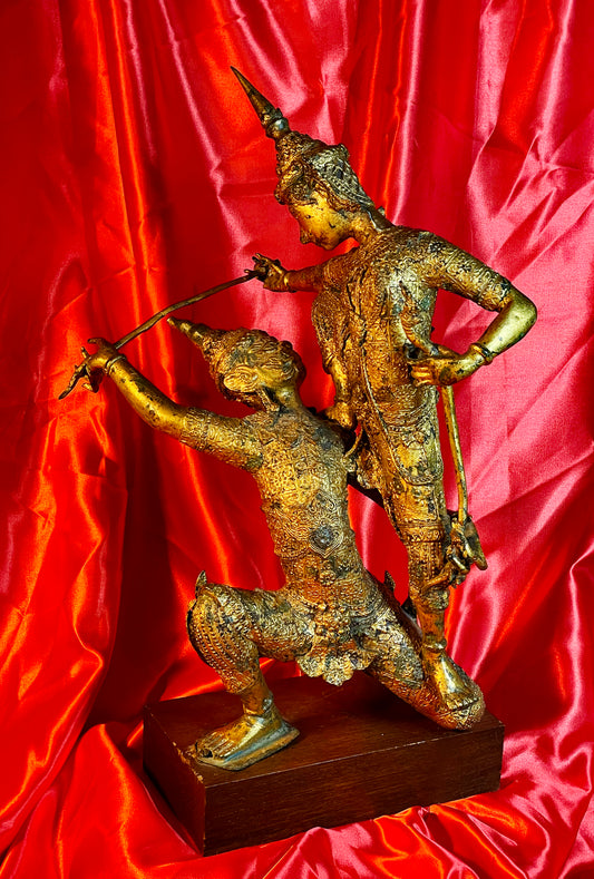 Antique Thai gilt bronze statue of two fighting temple guardians, front view on hardwood base