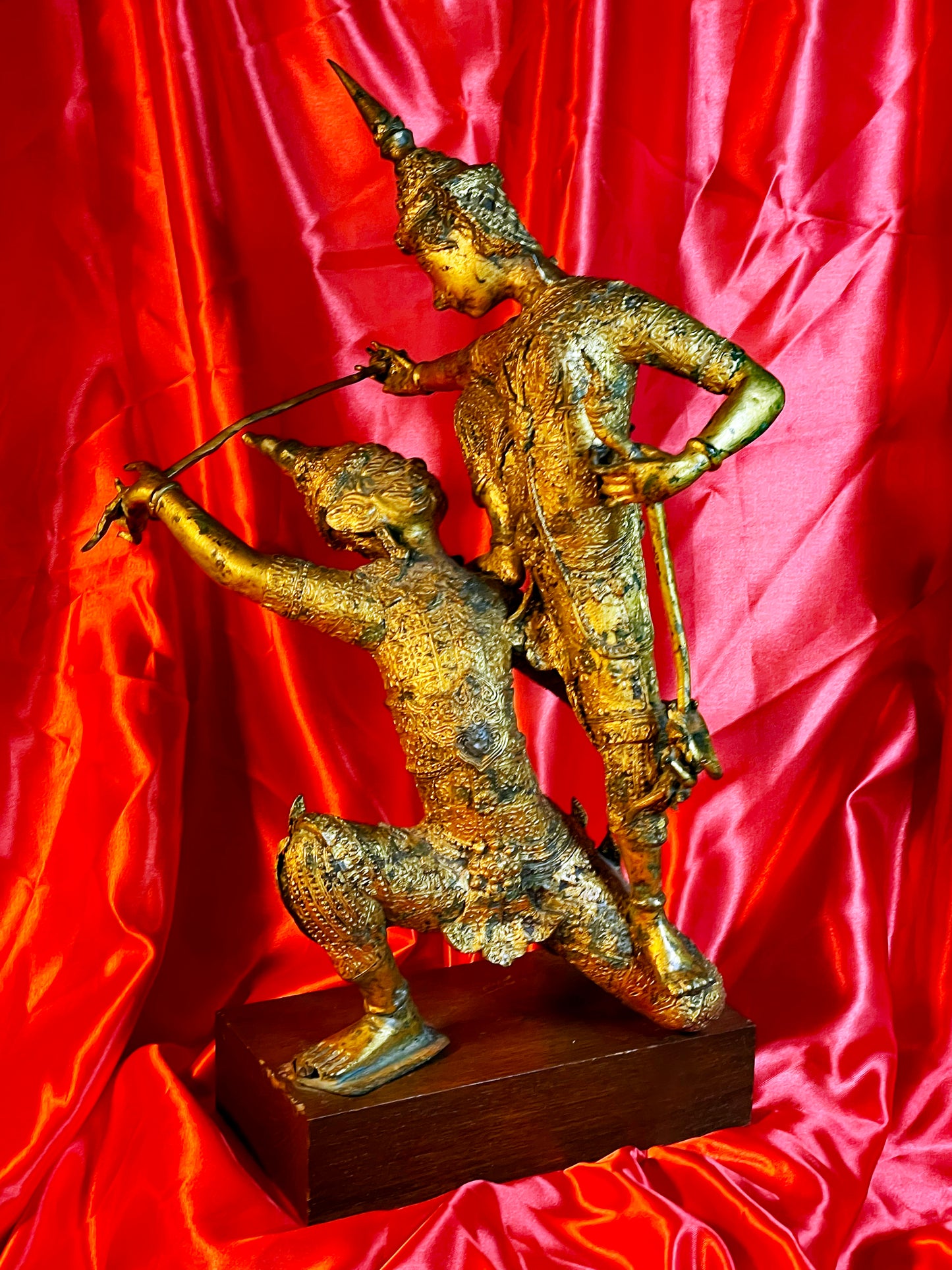 Gilt bronze Thai temple guardians, angled view showing combat pose