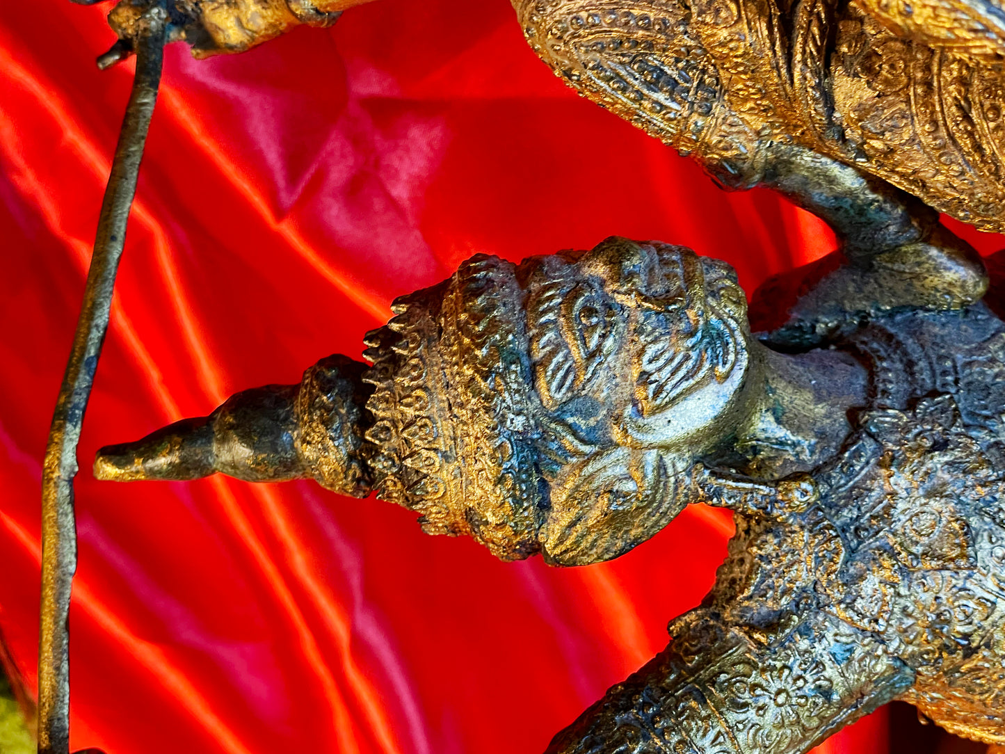 Detail of a crowned guardian head with chased ornament