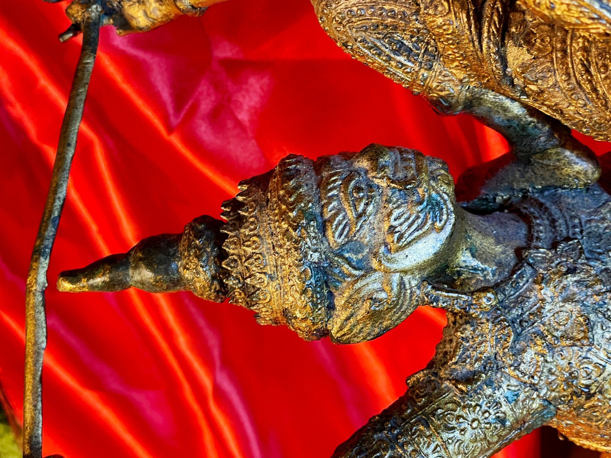Detail of a crowned guardian head with chased ornament