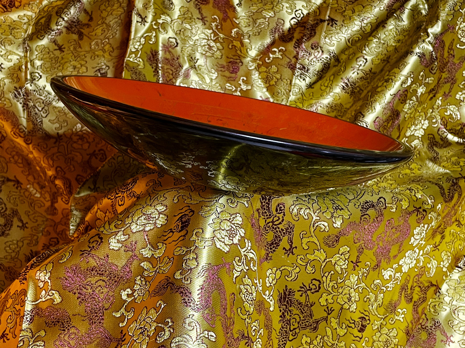 Profile view of the Chinese lacquer plate showing its shallow form and deep black rim