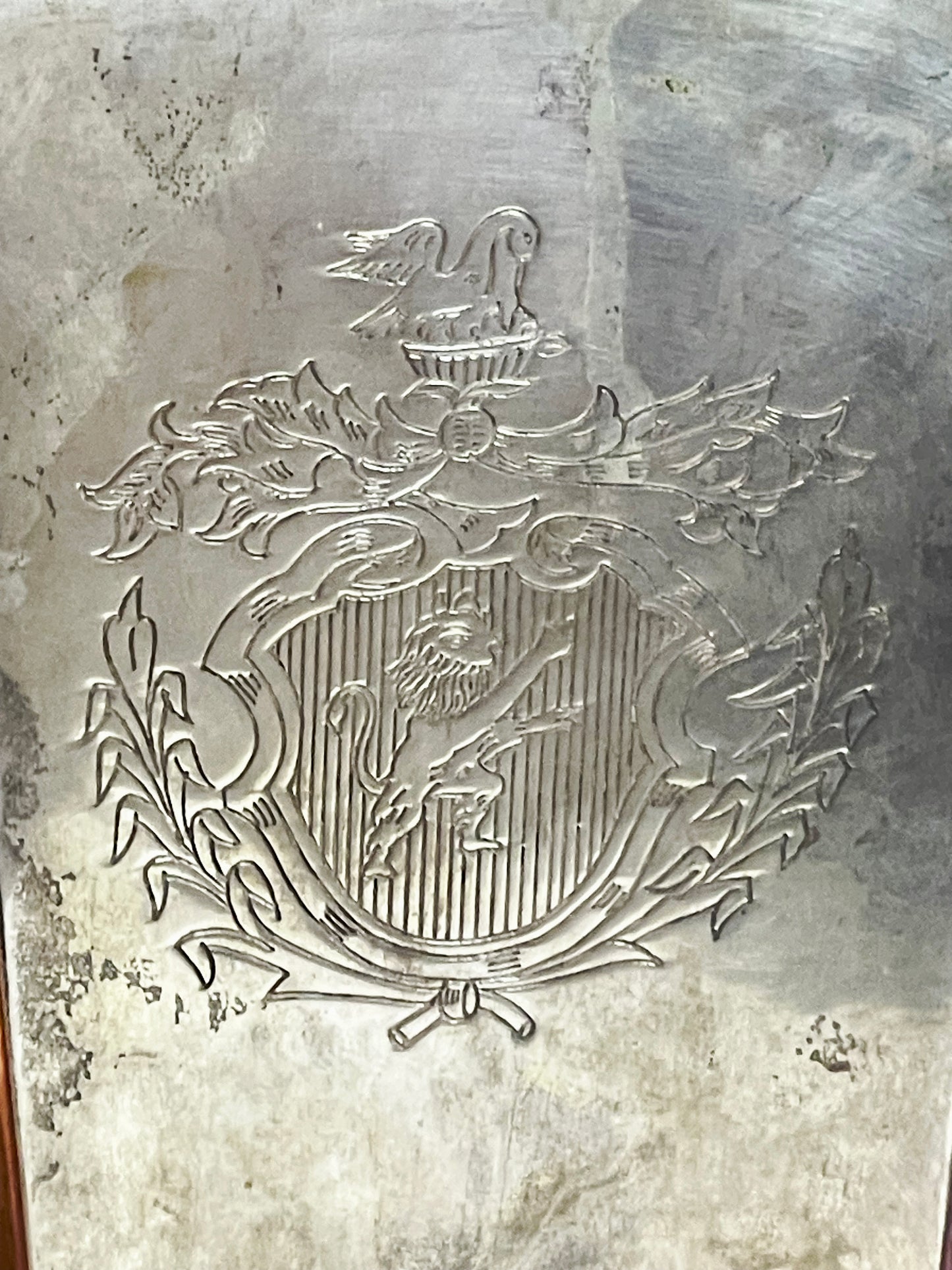 Close up of the engraved coat of arms, a lion within a laurel wreath