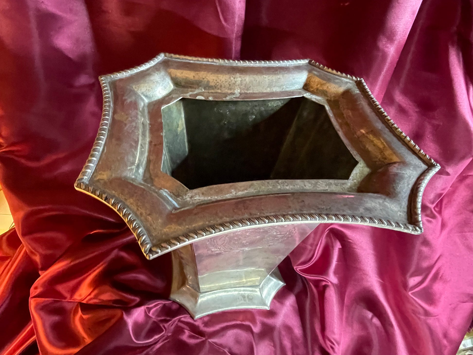 Top down view of the octagonal opening and gadrooned border of the silver wine cooler
