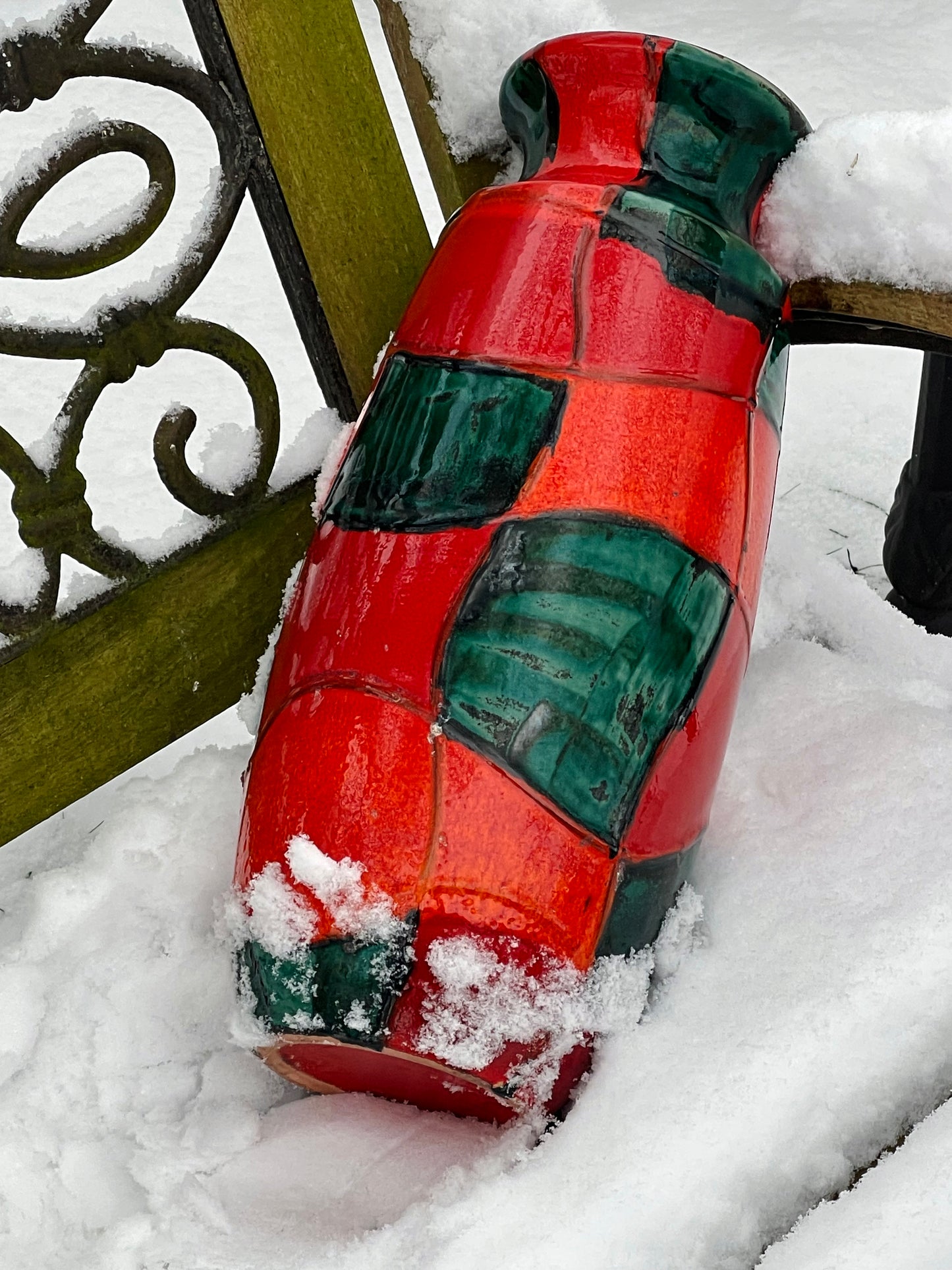 Profile view showing the cylindrical form and harlequin glaze pattern