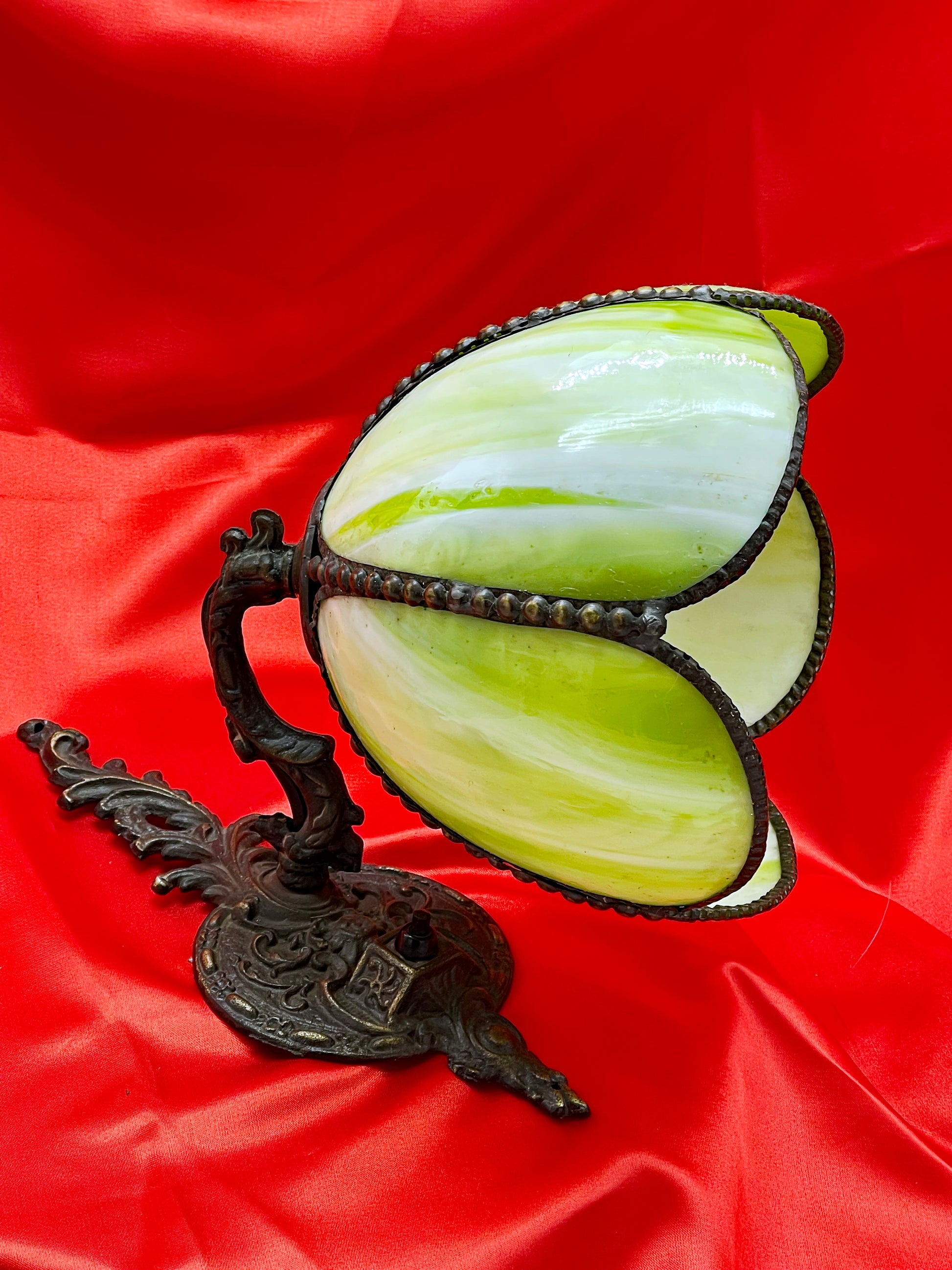 Angled view of the open tulip form glass shade in green, yellow and white