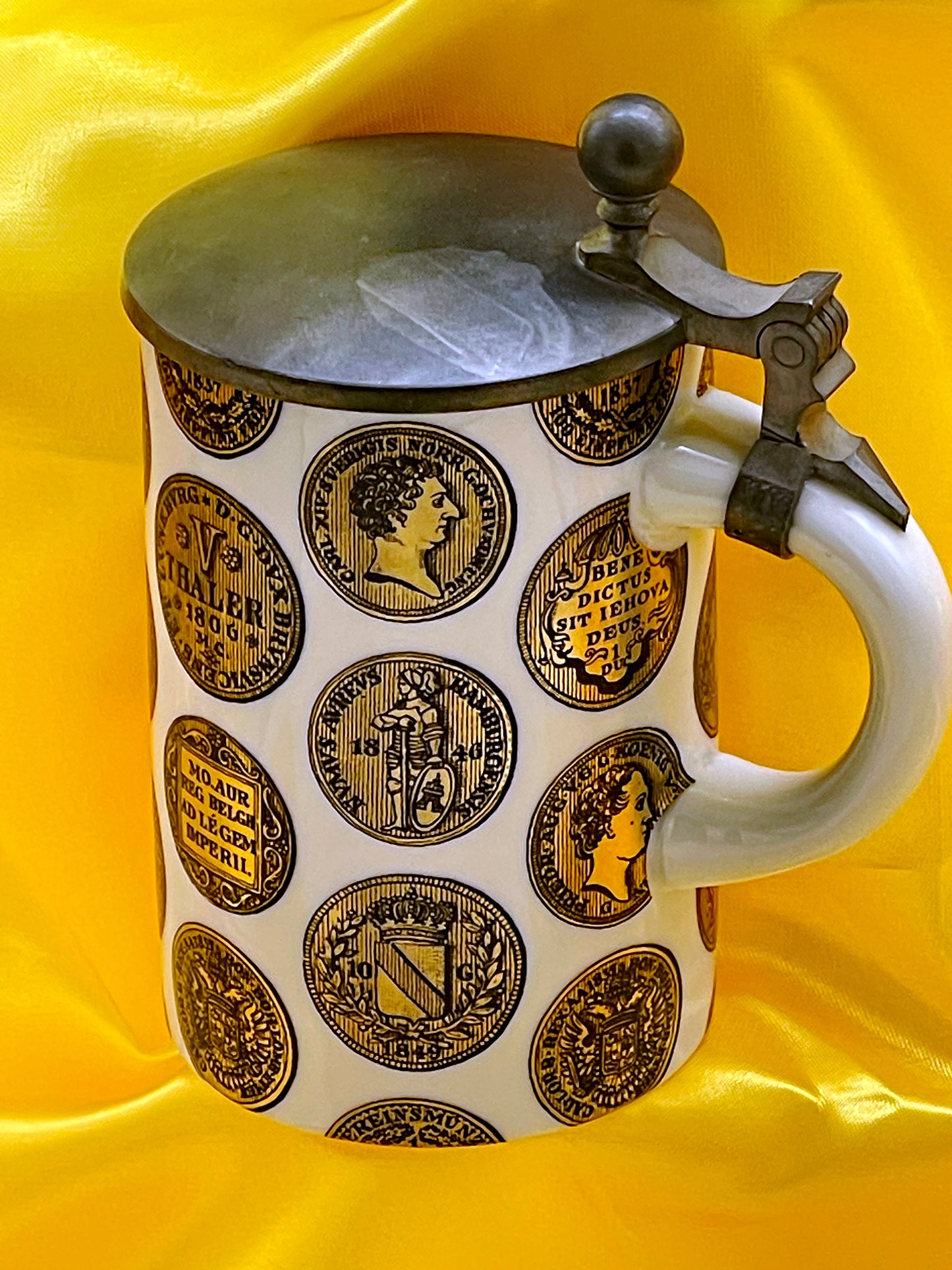 Top view of white Thaler coin stein showing gilded coin medallions and pewter lid