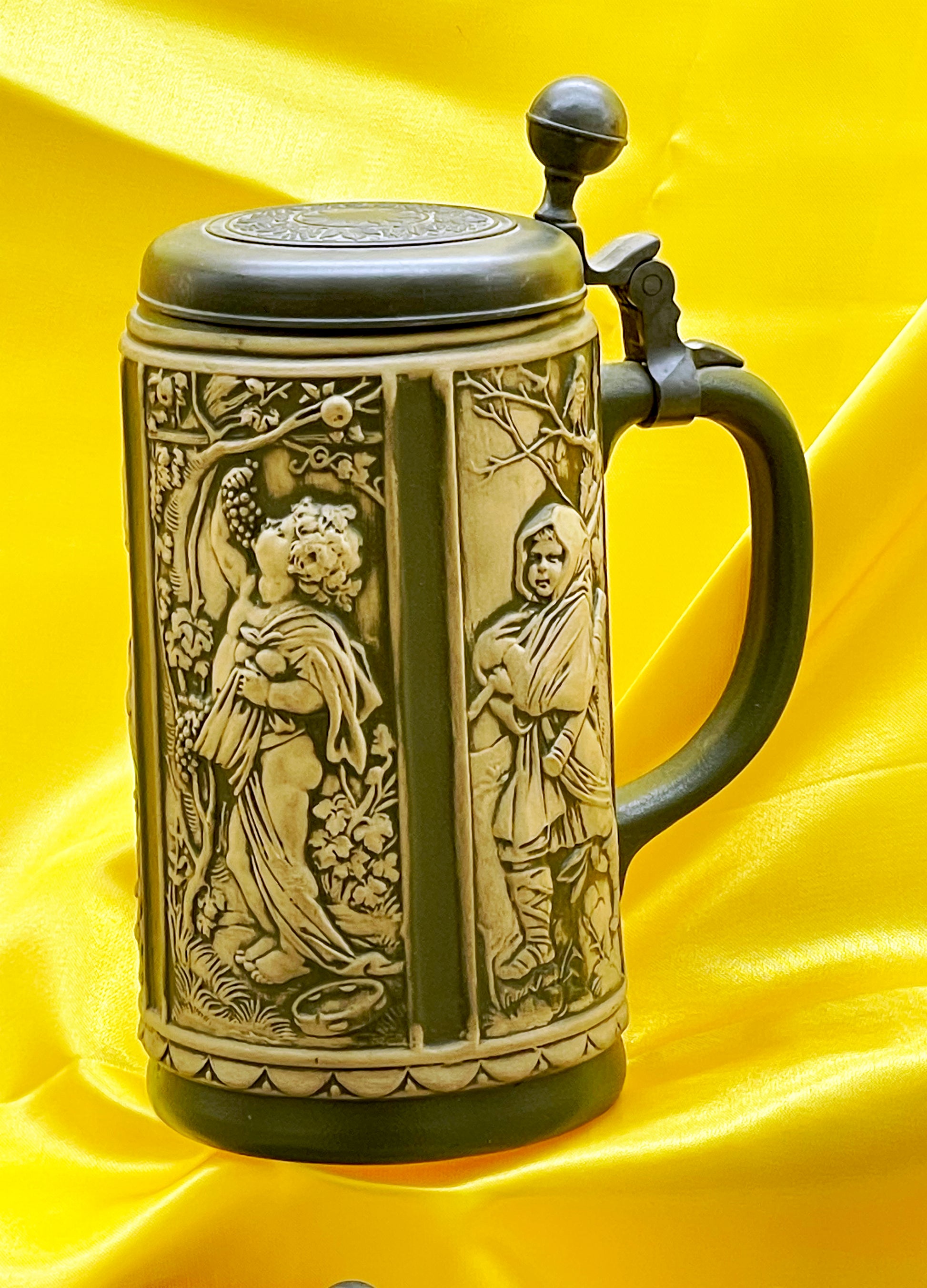 Antique German relief stoneware beer stein with classical seasonal figures and pewter lid