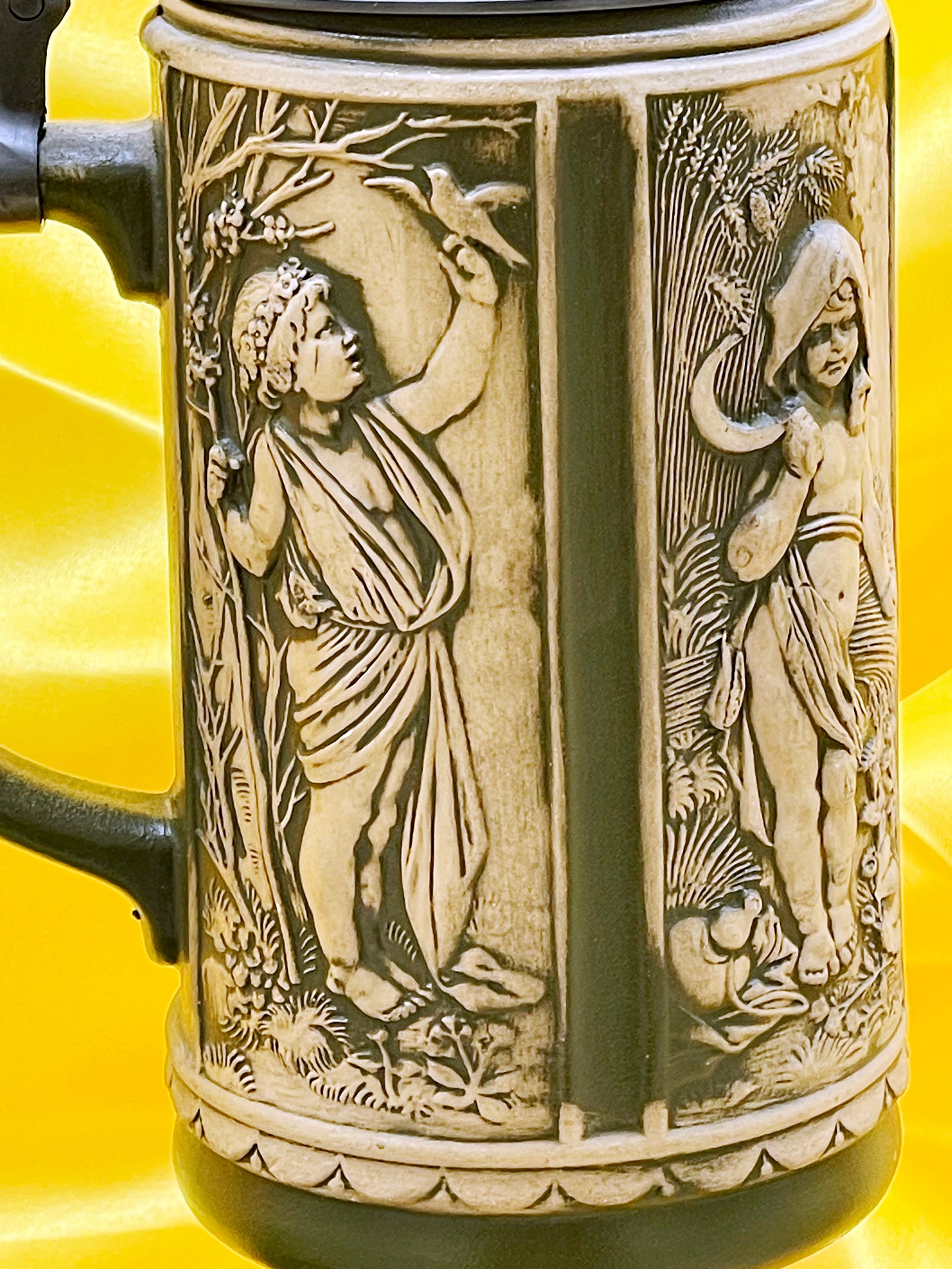 Close-up of gilded Thaler coin medallions including V Thaler 1806 on white stein