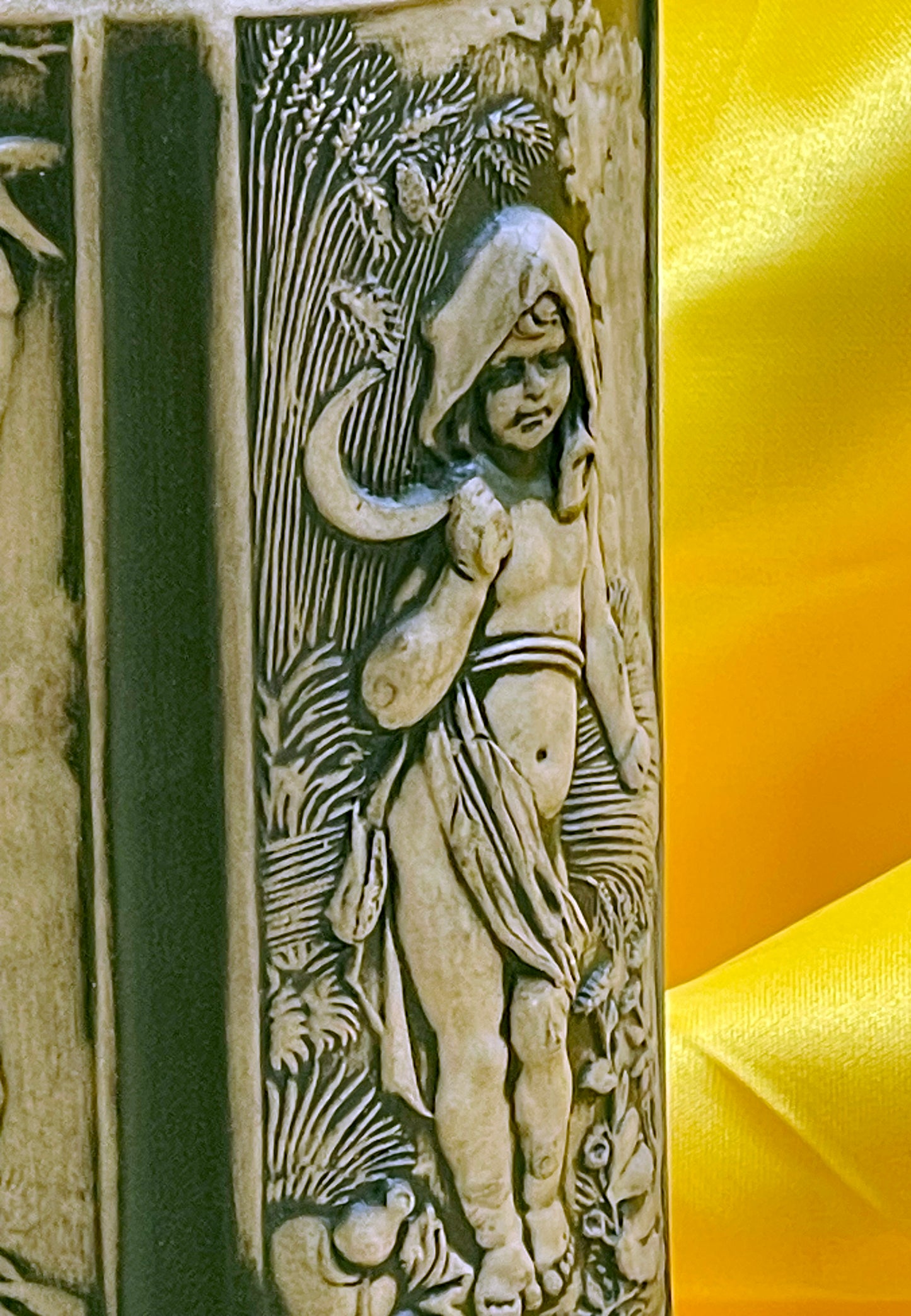 Close-up of relief figure with sickle and corn on antique German stein