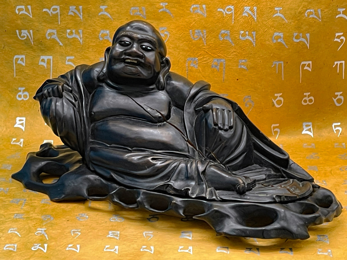 Reclining Buddha in heavy ebony, back and side carving detail
