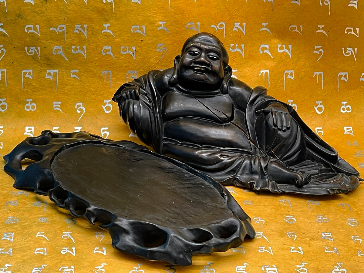 Detail of the ebony carving and patina of the antique Buddha
