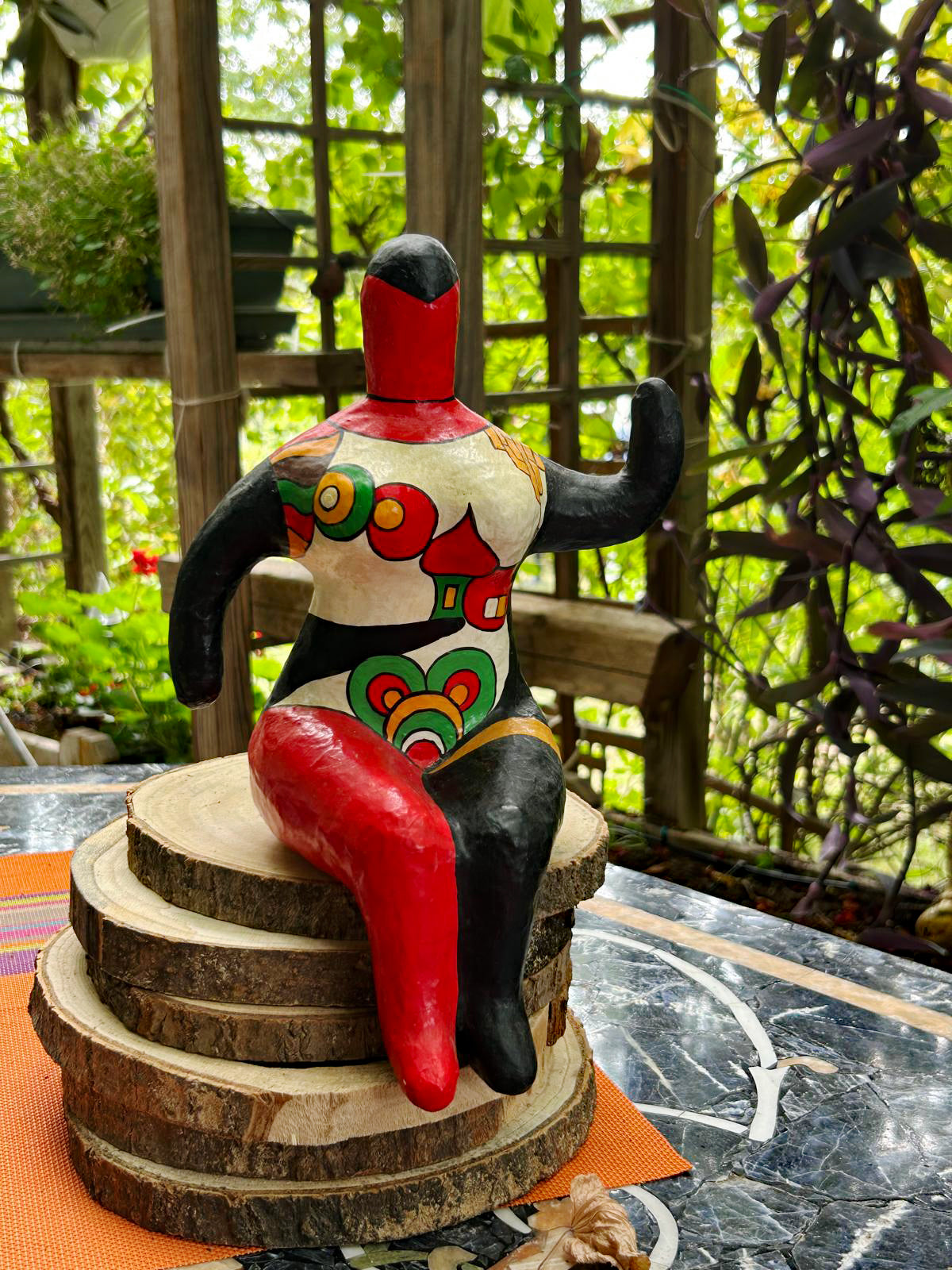 Nana-style seated female figure in the manner of Niki de Saint Phalle, front