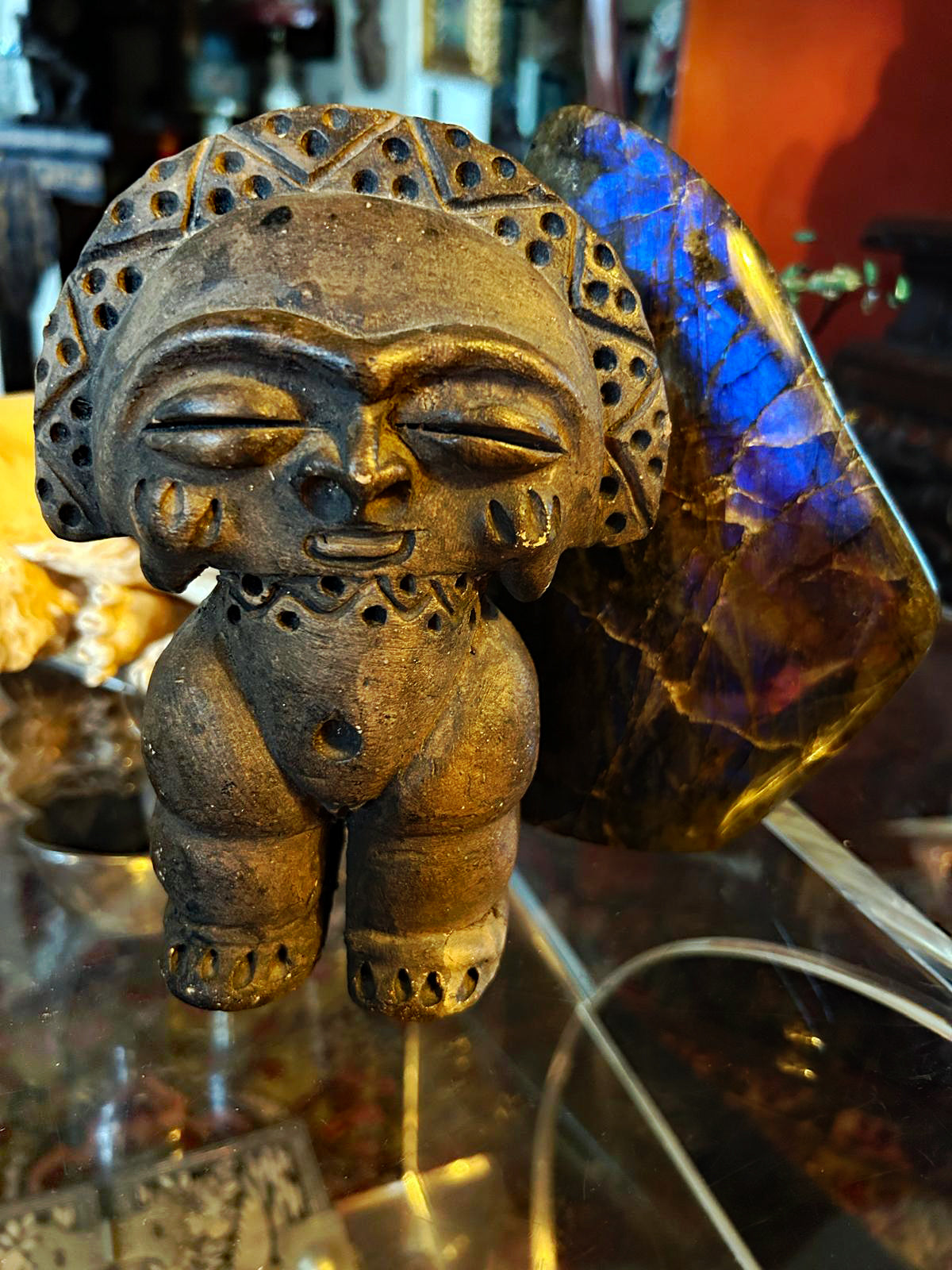 Hand-carved Taino-style stone figure, frontal close view of face and crown
