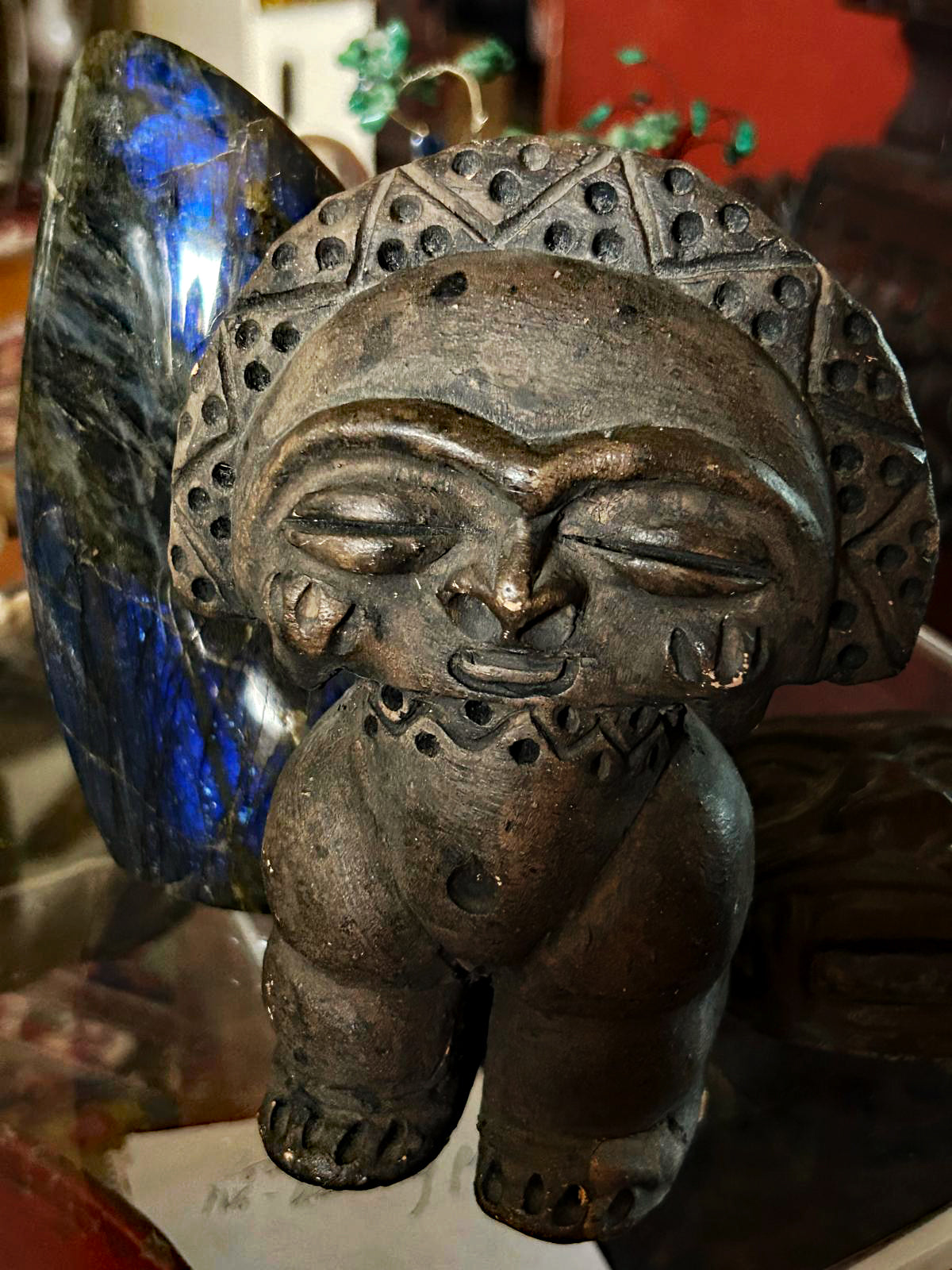 Taino-style stone idol, darker-toned three-quarter detail view